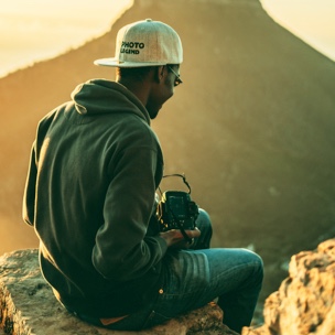 A man with a camera in a mountain